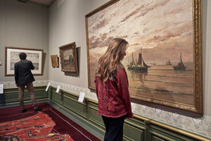 Woman looking at a painting in The Mesdag Collection